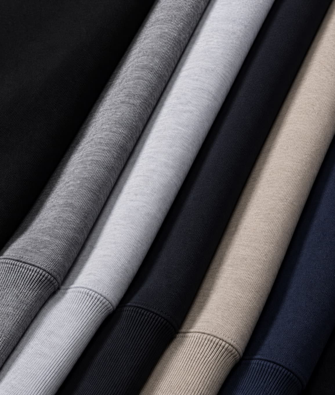 Cresyne blank tees folded in a row in grey, navy, taupe and black cotton